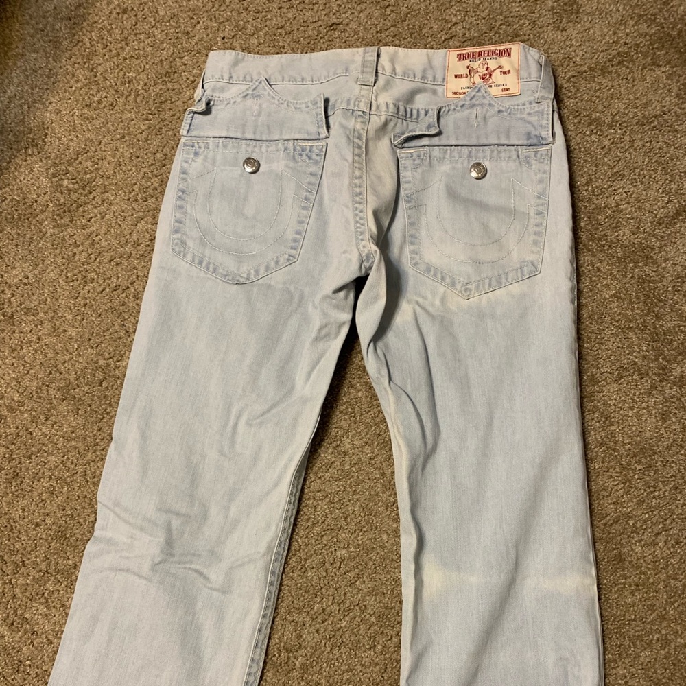 Men’s True Religion light wash jeans.
